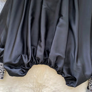 Loose satin blouse with long sleeves and batwing neck, with embroidered beads and high-quality sequins