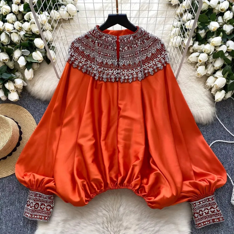 Loose satin blouse with long sleeves and batwing neck, with embroidered beads and high-quality sequins