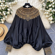 Loose satin blouse with long sleeves and batwing neck, with embroidered beads and high-quality sequins