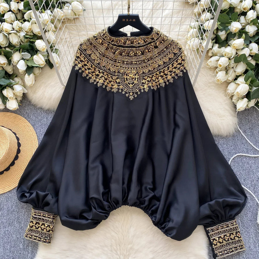Loose satin blouse with long sleeves and batwing neck, with embroidered beads and high-quality sequins
