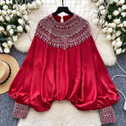Loose satin blouse with long sleeves and batwing neck, with embroidered beads and high-quality sequins