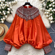 Loose satin blouse with long sleeves and batwing neck, with embroidered beads and high-quality sequins
