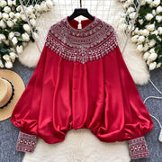 Loose satin blouse with long sleeves and batwing neck, with embroidered beads and high-quality sequins