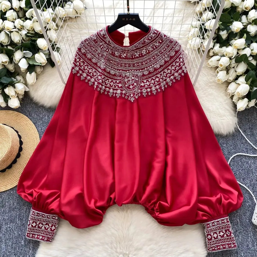 Loose satin blouse with long sleeves and batwing neck, with embroidered beads and high-quality sequins