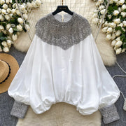 Loose satin blouse with long sleeves and batwing neck, with embroidered beads and high-quality sequins