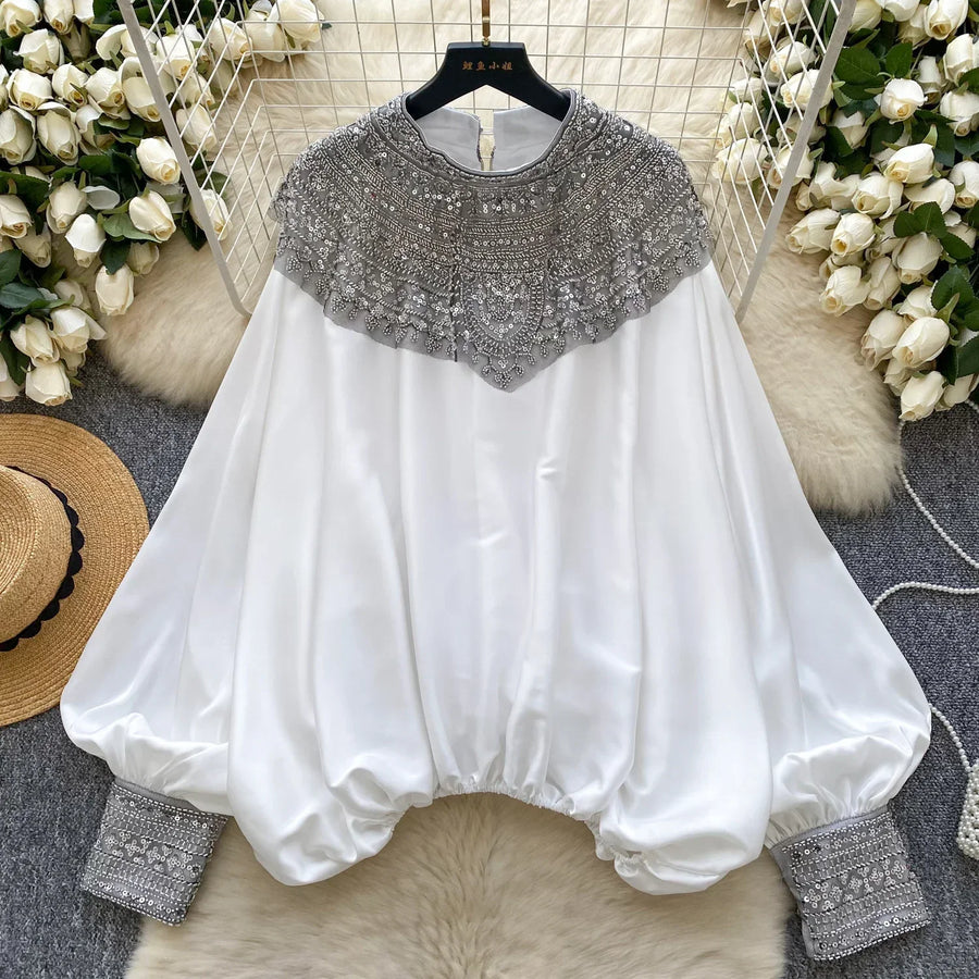 Loose satin blouse with long sleeves and batwing neck, with embroidered beads and high-quality sequins