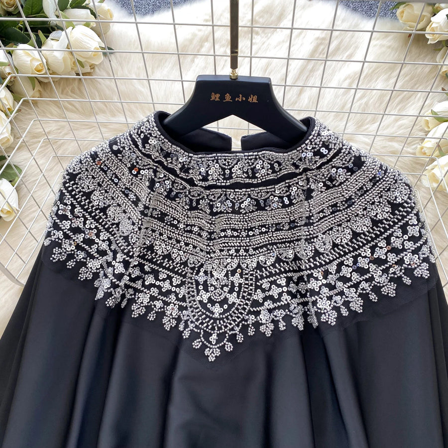 Loose satin blouse with long sleeves and batwing neck, with embroidered beads and high-quality sequins