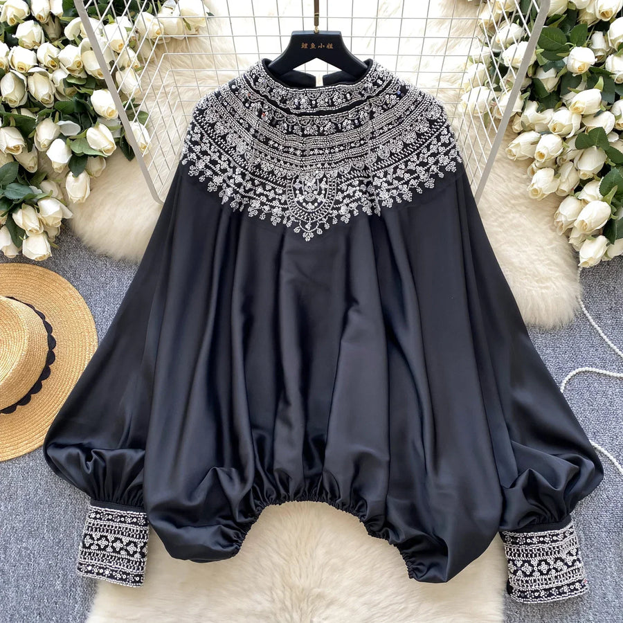 Loose satin blouse with long sleeves and batwing neck, with embroidered beads and high-quality sequins